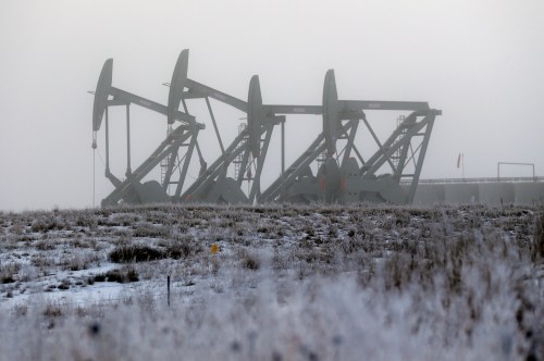 Eric Gay / The Associated Press files 
Oil pump jacks work in unison on a foggy morning in Williston, N.D. High crude prices catapulted North Dakota into the top tier of the global oil market and helped double or triple the size of once-sleepy towns that suddenly had to accommodate a small army of petroleum workers. But now that those prices have tumbled, the shifting oil market threatens to put the industry and local governments on a collision course.
