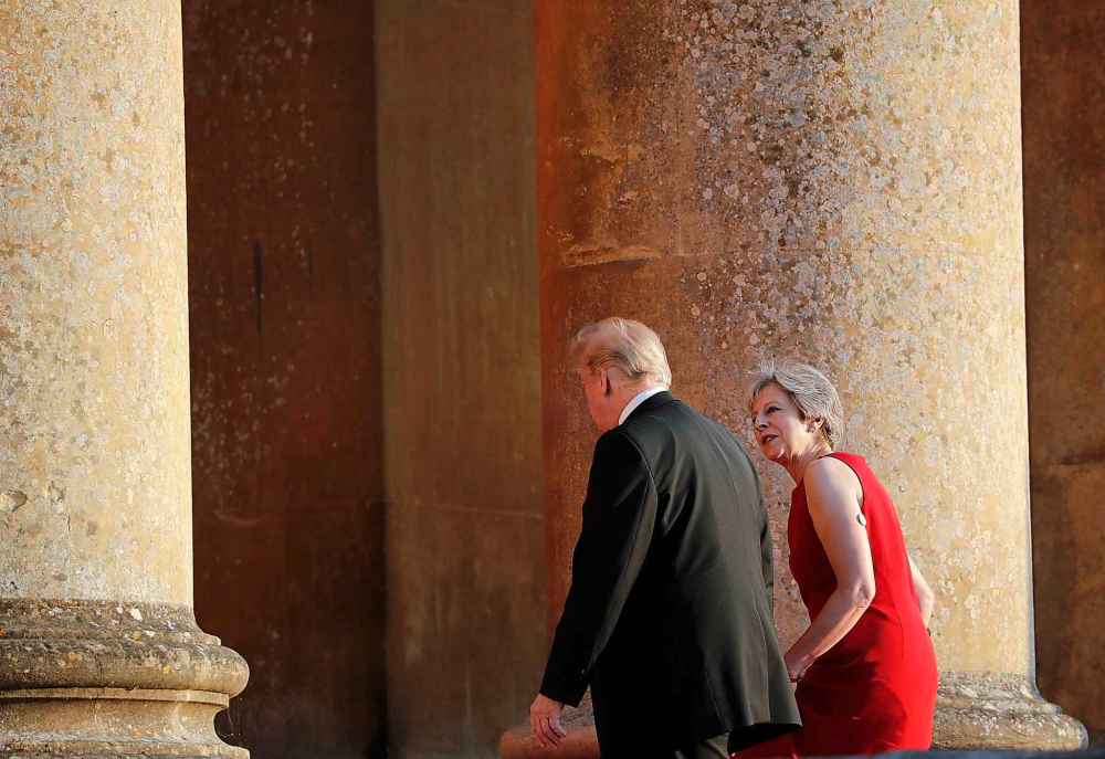 Pablo Martinez Monsivais / The Associated Press
British Prime Minister Theresa May, right, talks with President Donald Trump, left, as they walk into Blenheim Palace, Oxfordshire, where May will host a dinner as part of Trump's visit to the United Kingdom, Thursday.