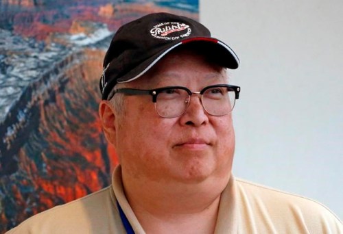 In this Tuesday, May 7, 2019, photo, Michael Kwan poses for a photograph in Salt Lake City. Kwan can't help but think about what life was like on a daily basis for his great-great-grandfather in the 1860s, working 12-hour days in California's Sierra Nevada mountain range on the Western portion of the Transcontinental Railroad that would reshape the American landscape. Kwan and other Chinese Americans are pushing for these workers some of whom lost their lives to get more than a token mention in history books as several days of celebrations kick off this week in Utah to commemorate the 150th anniversary of the completion Transcontinental Railroad. (AP Photo/Rick Bowmer)