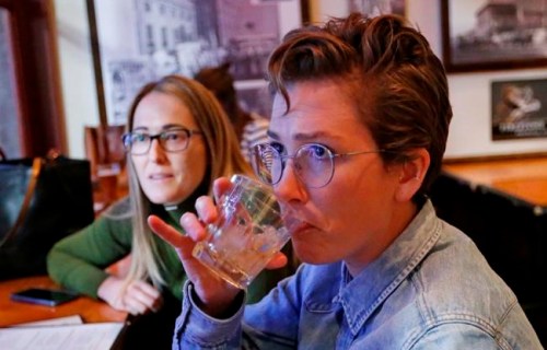 In this Dec. 20, 2018, photo, Maude Romney, 29, right, drinks at the Beer Hive Pub, in Salt Lake City. The United States' lowest DUI threshold takes effect this weekend in Utah. Stopping for a whiskey after work with her sister at the upscale pub Beerhive, Maude Romney, 29, said she'll likely only go to places she can walk to from her home downtown. 