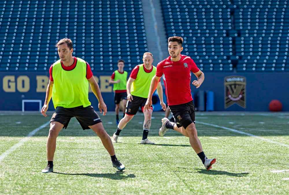 SASHA SEFTER / WINNIPEG FREE PRESS
Valour FC Midfielder Dylan Sacramento, right, runs through drills during a team practice on Investors Group Field, Thursday.