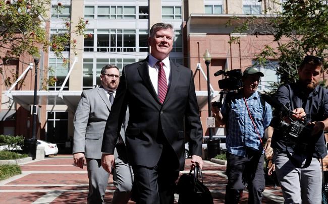 Kevin Downing, center, an attorney representing two Florida businessmen Lev Parnas and Igor Fruman, arrives at the federal courthouse in Alexandria, Va., Thursday, Oct. 10, 2019. The two Florida businessmen, tied to President Donald Trump's personal lawyer Rudy Giuliani, have been arrested on campaign finance violations resulting from a $325,000 donation to a political action committee supporting President Donald Trump's re-election. (AP Photo/Pablo Martinez Monsivais)