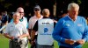 Co-leaders Scott Parel, left, and Tommy Toles, wearing cap, walk off the final hole at 12 under par, one stroke ahead of Colin Montgomerie, right, after the second round of the Dominion Energy Charity Classic golf tournament in Richmond, Va., Saturday, Oct. 19, 2019. Montgomerie missed a tying birdie attempt after engaging noisy fans in the stands. (Joe Mahoney/Richmond Times-Dispatch via AP)