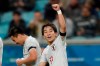 Japan's Koji Miyoshi celebrates after scoring his sides' second goal against Uruguay during a Copa America Group C soccer match at the Arena Gremio in Porto Alegre, Brazil, Thursday, June 20, 2019. (AP Photo/Silvia Izquierdo)