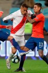 Peru's Paolo Guerrero, left, vies for the ball with Chile's Erick Pulgar, right, during a Copa America semifinal soccer match at the Arena do Gremio in Porto Alegre, Brazil, Wednesday, July 3, 2019. (AP Photo/Andre Penner)