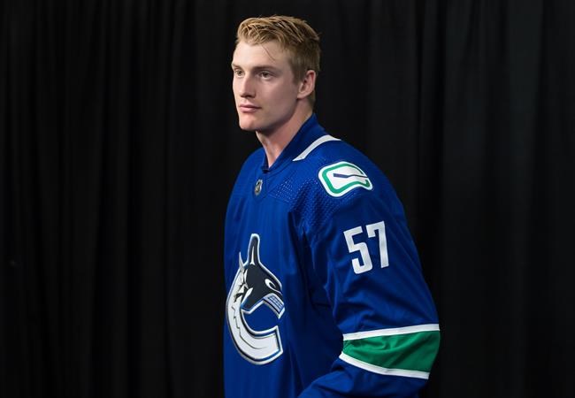 Vancouver Canucks defenceman Tyler Myers stands to leave after a news conference after signing a five-year contract with the NHL hockey team, in Vancouver, on Monday July 1, 2019. THE CANADIAN PRESS/Darryl Dyck