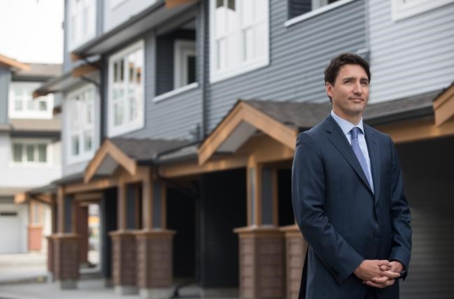 Prime Minister Justin Trudeau listens while being introduced before a post-budget housing announcement at a townhouse development in Maple Ridge, B.C., on Monday March 25, 2019. THE CANADIAN PRESS/Darryl Dyck