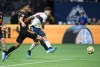 Vancouver Whitecaps' Fredy Montero, back right, scores a goal as Houston Dynamo's Jose Bizama watches during the second half of an MLS soccer game in Vancouver, on Saturday September 14, 2019. THE CANADIAN PRESS/Darryl Dyck