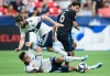 Vancouver Whitecaps' Jake Nerwinski, bottom left, and teammate Jon Erice, top left, collide while vying for the ball against San Jose Earthquakes' Shea Salinas, back right, during the second half of an MLS soccer game in Vancouver, on Saturday July 20, 2019. THE CANADIAN PRESS/Darryl Dyck