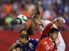 Netherlands' Anouk Dekker, back right, gets her head on the ball but fails to score as Japan goalkeeper Ayumi Kaihori (18) reaches for the ball and Rumi Utsugi (13) defends during second half FIFA Women's World Cup round of 16 soccer action in Vancouver, B.C., on Tuesday June 23, 2015. THE CANADIAN PRESS/Darryl Dyck