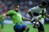 Vancouver Whitecaps' Russell Teibert (31) kicks the ball near Seattle Sounders' Victor Rodriguez (8) during the first half MLS soccer action in Vancouver, B.C., on Saturday March 30, 2019. THE CANADIAN PRESS/Ben Nelms