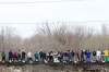Tim Smith/Brandon Sun
Volunteers hoist sandbags to help stabilize aqua dams on the dike along the south side of the Assiniboine River on Monday.
