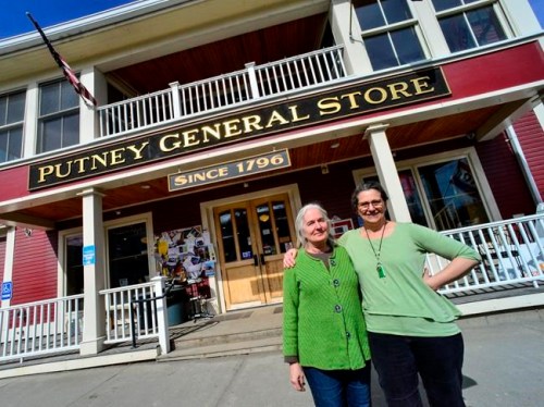 In this Tuesday, April 2, 2019 photo, Betsy MacIsaac, left, and Lyssa Papazian, pose outside the Putney General Store in Putney, Vt. The pari have been the volunteers from the Putney Historical Society who have run the store for the historical society for the last two years. But after two years of volunteering and 10-hour days, they are seeking a new store owner. (Kristopher Radder/The Brattleboro Reformer via AP)