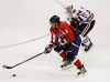 Washington Capitals' Alex Ovechkin (8), of Russia, moves the puck on Chicago Blackhawks' Dylan Olsen (34) during the third period of an NHL preseason hockey game, Sunday, Oct. 2, 2011, in Washington. The Capitals won 4-1. (AP Photo/Luis M. Alvarez)