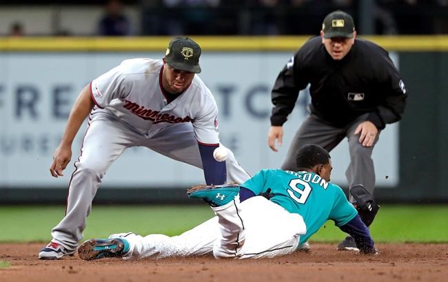 The ball pops away from Minnesota Twins second baseman Jonathan Schoop, left, as Seattle Mariners' Dee Gordon steals second base during the third inning of a baseball game Friday, May 17, 2019, in Seattle. (AP Photo/Elaine Thompson)