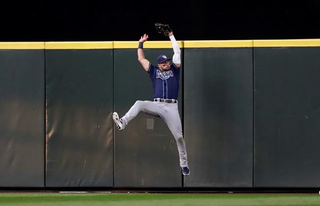 Tampa Bay Rays center fielder Kevin Kiermaier leaps at the wall to catch a deep fly ball from Seattle Mariners' Mallex Smith duringp the third inning of a baseball game Saturday, Aug. 10, 2019, in Seattle. (AP Photo/Elaine Thompson)