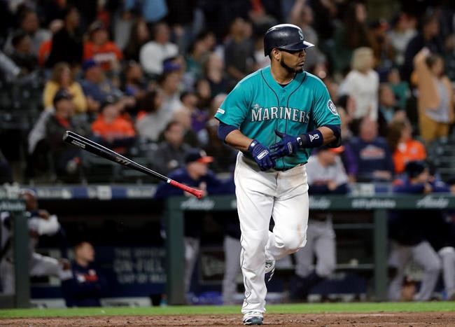 Seattle Mariners' Edwin Encarnacion tosses aside his bat after hitting a three-run home run against the Houston Astros durng the sixth inning of a baseball game Wednesday, June 5, 2019, in Seattle. (AP Photo/Elaine Thompson)