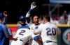 Seattle Mariners' J.P. Crawford, center, smiles as he is mobbed by teammates after hitting in the winning run with a single to defeat the Detroit Tigers in the 10th inning of a baseball game Sunday, July 28, 2019, in Seattle. (AP Photo/Elaine Thompson)