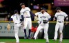 Seattle Mariners' Tim Beckham (1), Mallex Smith, Domingo Santana and Mitch Haniger celebrate after the team beat the Los Angeles Angels in a baseball game, Tuesday, April 2, 2019, in Seattle. The Mariners won 2-1. (AP Photo/Elaine Thompson)