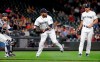 Seattle Mariners first baseman Edwin Encarnacion, center, holds on to the ball after fielding a bunt single from Houston Astros' Tony Kemp as catcher Omar Narvaez, left, and relief pitcher Jesse Biddle watch during the eighth inning of a baseball game Tuesday, June 4, 2019, in Seattle. (AP Photo/Elaine Thompson)