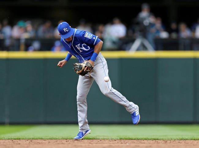 Kansas City Royals shortstop Nicky Lopez blocks a ground ball hit by Seattle Mariners' Daniel Vogelbach, before throwing him out at first during the third inning of a baseball game Wednesday, June 19, 2019, in Seattle. (AP Photo/John Froschauer)