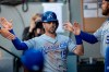 Kansas City Royals' Whit Merrifield is congratulated by teammates after scoring a run on a single by teammate Cheslor Cuthbert off Seattle Mariners starting pitcher Tayler Scott during the first inning of a baseball game, Monday, June 17, 2019, in Seattle. (AP Photo/Stephen Brashear)