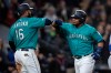 Seattle Mariners' Edwin Encarnacion, right, is congratulated by Domingo Santana after hitting a three-run home run off of Texas Rangers starting pitcher Shelby Miller that also scored Santana and Daniel Vogelbach during the third inning of a baseball game, Friday, April 26, 2019, in Seattle. (AP Photo/Stephen Brashear)