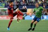 Real Salt Lake forward Jefferson Savarino, left, kicks the ball as Seattle Sounders defender Brad Smith, right, defends during the first half of an MLS Western Conference semifinal playoff soccer match Wednesday, Oct. 23, 2019, in Seattle. (AP Photo/Ted S. Warren)