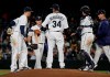 Seattle Mariners starting pitcher Felix Hernandez (34) talks to teammates on the mound as manager Scott Servais, right, walks out to pull him from a baseball game against the Los Angeles Angels during the sixth inning, Monday, April 1, 2019, in Seattle. (AP Photo/Ted S. Warren)