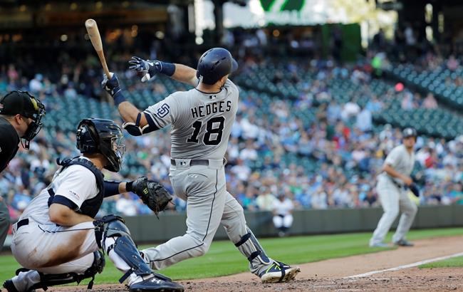 San Diego Padres' Austin Hedges follows through on a swing during the fourth inning of a baseball game against the Seattle Mariners, Wednesday, Aug. 7, 2019, in Seattle. Hedges popped out on the at-bat. (AP Photo/Ted S. Warren)
