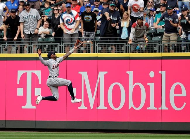 Detroit Tigers right fielder Niko Goodrum leaps, but can't catch a double hit by Seattle Mariners' Tim Beckham during the fifth inning of a baseball game, Saturday, July 27, 2019, at T-Mobile Park in Seattle. (AP Photo/Ted S. Warren)