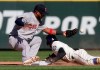 Seattle Mariners' Dee Gordon, right safely steals second base as the ball pops out of the glove of Boston Red Sox second baseman Eduardo Nunez during the seventh inning of a baseball game, Sunday, March 31, 2019, in Seattle. (AP Photo/Ted S. Warren)