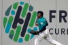 Seattle Mariners left fielder Shed Long runs next to a graphic on the outfield wall after catching a line-out by Oakland Athletics' Marcus Semien during the sixth inning of a baseball game, Friday, Sept. 27, 2019, in Seattle. (AP Photo/Ted S. Warren)
