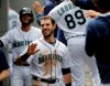 Seattle Mariners' Austin Nola, center, and Kristopher Negron, left, are greeted in the dugout after they scored in the seventh inning of a baseball game against the Detroit Tigers on a ground-rule double hit by teammate Ryan Court, Saturday, July 27, 2019, in Seattle. (AP Photo/Ted S. Warren)