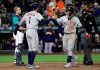 Houston Astros' Yuli Gurriel, right, is greeted at the plate by Carlos Correai (1) as Seattle Mariners catcher Tom Murphy, left, waits after Gurriel hit a grand slam during the eighth inning of a baseball game Friday, April 12, 2019, in Seattle. (AP Photo/Ted S. Warren)