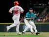 Seattle Mariners starting pitcher Mike Leake, right, prepares to put out Los Angeles Angels' Kole Calhoun, who grounded out to him during the eighth inning of a baseball game Friday, July 19, 2019, in Seattle. (AP Photo/Ted S. Warren)