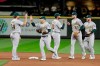 Oakland Athletics players greet each other after the team's 3-1 over the Seattle Mariners in a baseball game Thursday, Sept. 26, 2019, in Seattle. (AP Photo/Ted S. Warren)
