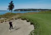 In this May 6, 2019, photo, PGA golf professional Jacob Lippold hits from a bunker onto the third green at Chambers Bay, in University Place, Wash. Four years removed from the U.S. Open golf championship that was largely derided for its putting green problems, Chambers Bay may have salvaged its future in the championship rotation with a massive undertaking to replace every green on the course. (AP Photo/Ted S. Warren)