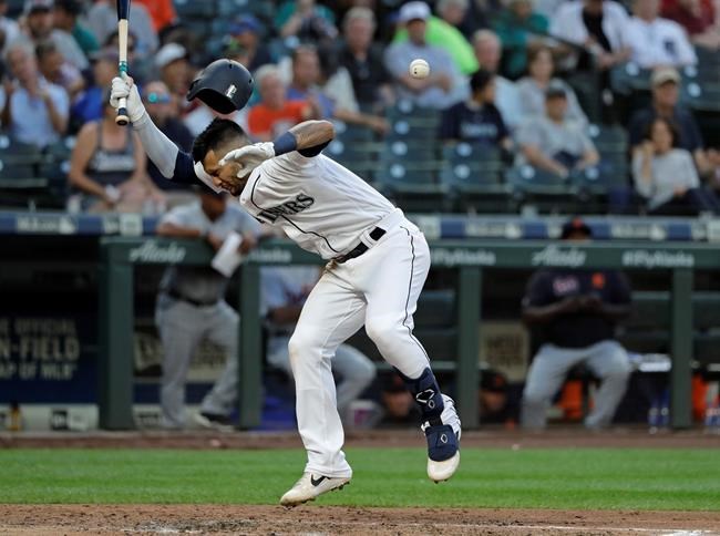 Seattle Mariners' Tim Lopes gets hit by a pitch during the fourth inning of a baseball game against the Detroit Tigers, Thursday, July 25, 2019, in Seattle. Lopes remained in the game. (AP Photo/Ted S. Warren)