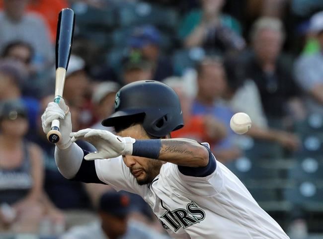 Seattle Mariners' Tim Lopes gets hit by a pitch during the fourth inning of a baseball game against the Detroit Tigers, Thursday, July 25, 2019, in Seattle. Lopes remained in the game. (AP Photo/Ted S. Warren)