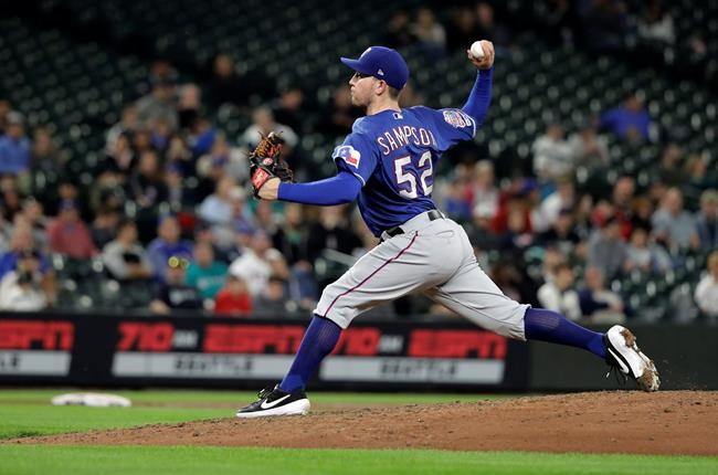 Texas Rangers starting pitcher Adrian Sampson throws during the sixth inning of a baseball game against the Seattle Mariners, Tuesday, May 28, 2019, in Seattle. Rangers pitcher Jesse Chavez pitched for the first inning. (AP Photo/Ted S. Warren)