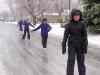 Andrea Loken / The Canadian Press
Kids skate on an ice-covered street in Kingston, Ont., on Saturday.