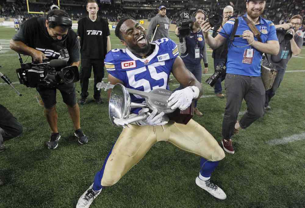 John Woods / The Canadian Press Files
Winnipeg Blue Bombers' Jamaal Westerman (55) strums the Banjo Bowl after defeating the Saskatchewan Roughriders in CFL action this year. Westermann earned half of the Bombers' team awards including most outstanding player, top defensive players and top Canadian.