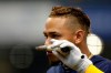 Milwaukee Brewers' Orlando Arcia puts the remains of his broken bat to his nose after grounding out during the sixth inning of a baseball game against the Pittsburgh Pirates, Sunday, Sept. 22, 2019, in Milwaukee. (AP Photo/Aaron Gash)