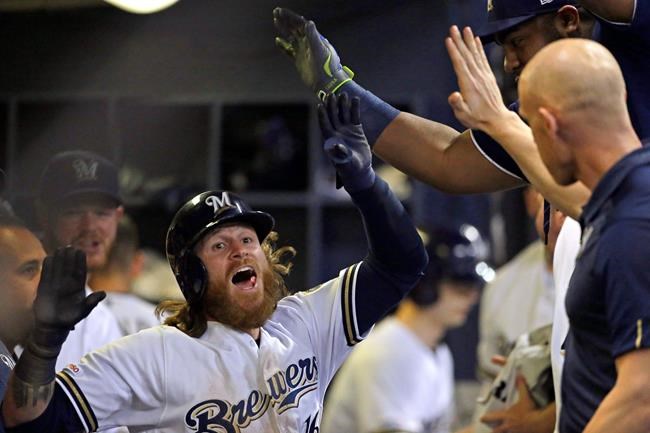 Milwaukee Brewers' Ben Gamel is congratulated in the dugout after hitting an inside-the-park home run during the sixth inning of the team's baseball game against the Seattle Mariners on Wednesday, June 26, 2019, in Milwaukee. (AP Photo/Aaron Gash)