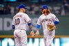 Milwaukee Brewers' Ben Gamel, right, and Yasmani Grandal congratulate one another after the team's baseball game against the Pittsburgh Pirates on Friday, Sept. 20, 2019, in Milwaukee. The Brewers won 10-1. (AP Photo/Aaron Gash)