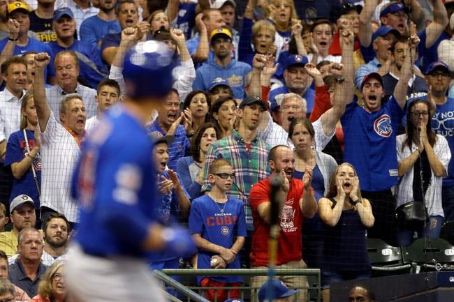 Fans react as Chicago Cubs' Anthony Rizzo draws a bases-loaded walk to score a run during the eighth inning of a baseball game against the Milwaukee Brewers, Saturday, Sept. 7, 2019, in Milwaukee. (AP Photo/Aaron Gash)