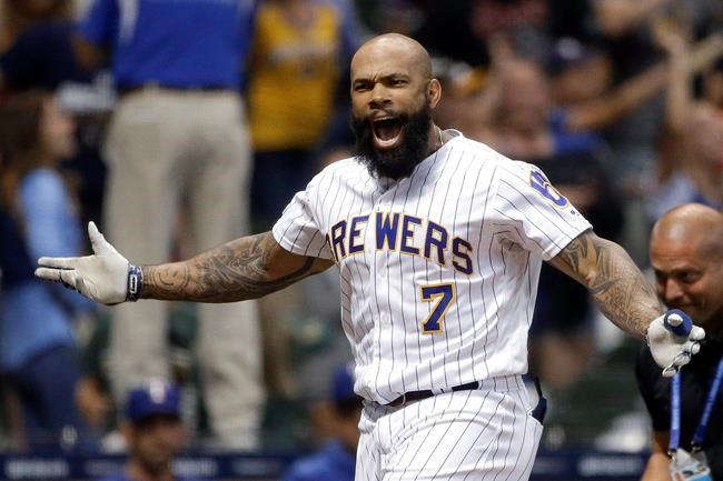 Milwaukee Brewers' Eric Thames gestures after hitting a game-ending solo home run against the Texas Rangers in a baseball game Friday, Aug. 9, 2019, in Milwaukee. The Brewers won 6-5. (AP Photo/Aaron Gash)