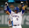 Milwaukee Brewers' Manny Pina (9) reacts in front of Los Angeles Dodgers' Chris Taylor after his double during the fifth inning of a baseball game Saturday, April 20, 2019, in Milwaukee. (AP Photo/Jeffrey Phelps)