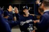 Milwaukee Brewers' Christian Yelich is congratulated after hitting a home run during the first inning of a baseball game against the St. Louis Cardinals Saturday, March 30, 2019, in Milwaukee. (AP Photo/Morry Gash)